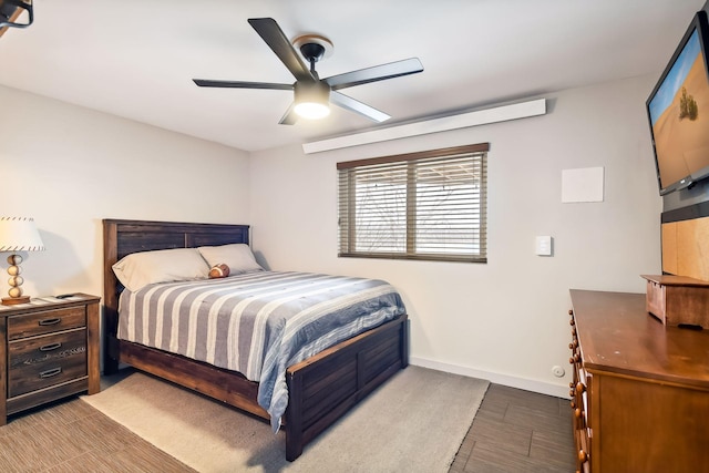 bedroom featuring baseboards, a ceiling fan, and wood finished floors