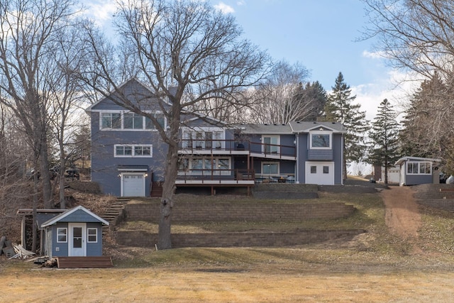 view of front of property with an outbuilding, a shed, a front yard, and a wooden deck