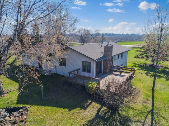 19447 County Road 1, Morris, MN 56267 - back of house featuring a deck, a shingled roof, a lawn, and a chimney