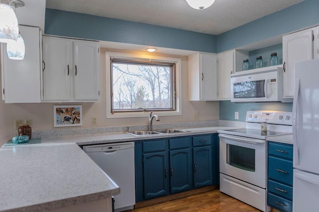 19447 County Road 1, Morris, MN 56267 - kitchen with a sink, white appliances, white cabinetry, and blue cabinetry