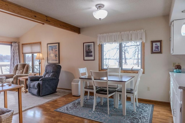 19447 County Road 1, Morris, MN 56267 - dining space with baseboards, a textured ceiling, vaulted ceiling with beams, and wood finished floors