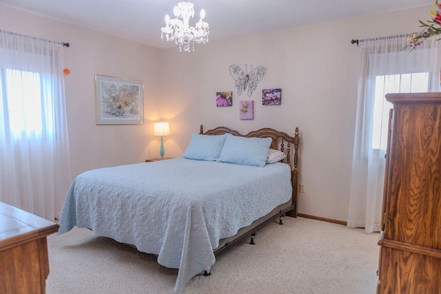 19447 County Road 1, Morris, MN 56267 - carpeted bedroom with multiple windows, baseboards, and an inviting chandelier