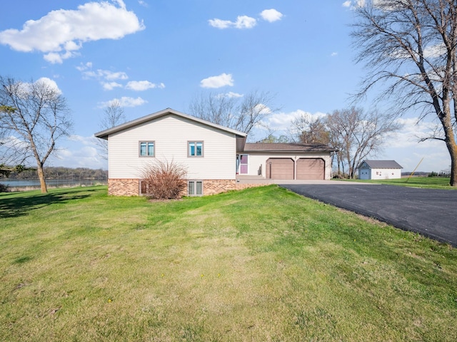19447 County Road 1, Morris, MN 56267 - view of side of home with an attached garage, asphalt driveway, a water view, and brick siding
