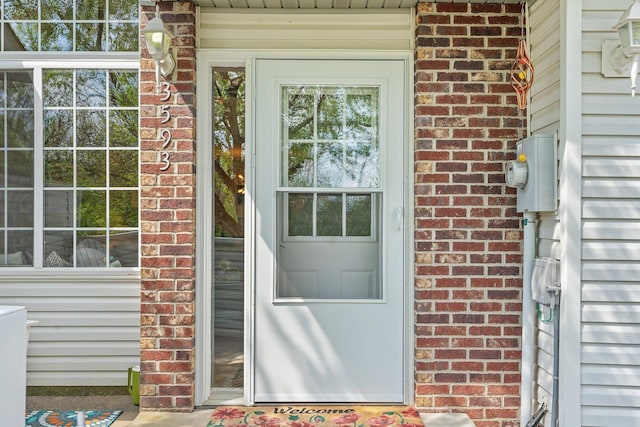property entrance featuring brick siding
