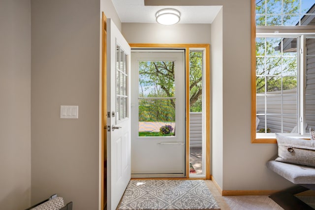 entrance foyer with baseboards and light tile patterned flooring