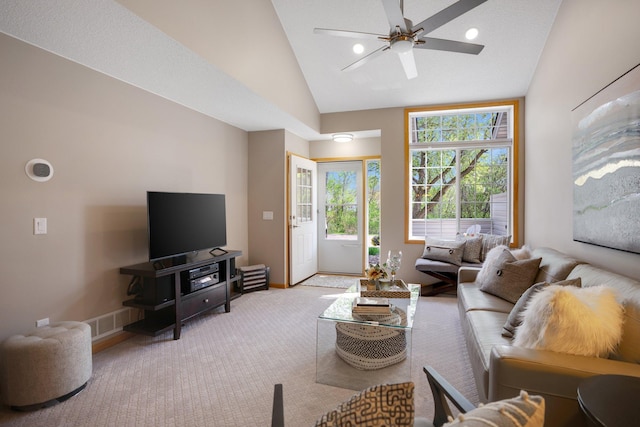 living area featuring baseboards, carpet, a ceiling fan, and high vaulted ceiling