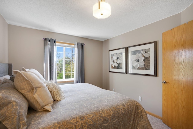 carpeted bedroom with a textured ceiling