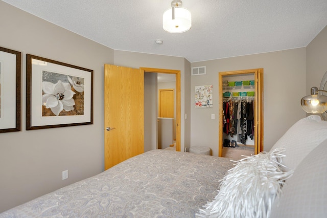 bedroom with a walk in closet and a closet