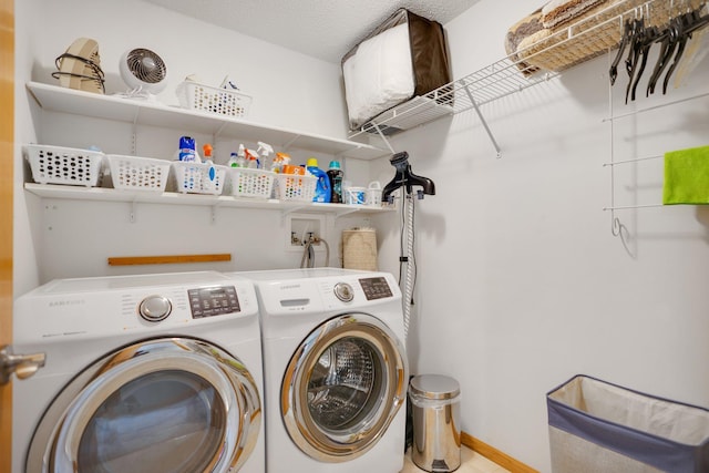 clothes washing area with washing machine and clothes dryer