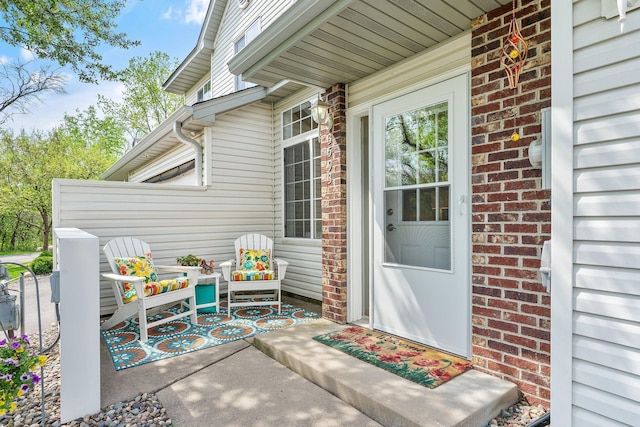 property entrance featuring brick siding