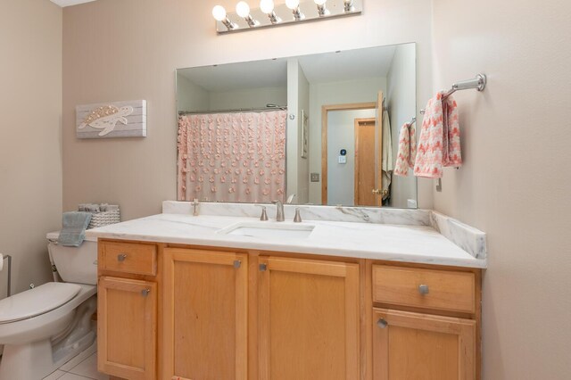 full bath featuring vanity, tile patterned flooring, toilet, and curtained shower