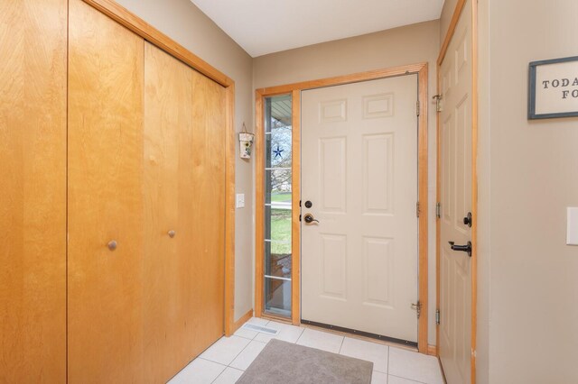 entrance foyer with baseboards and light tile patterned flooring