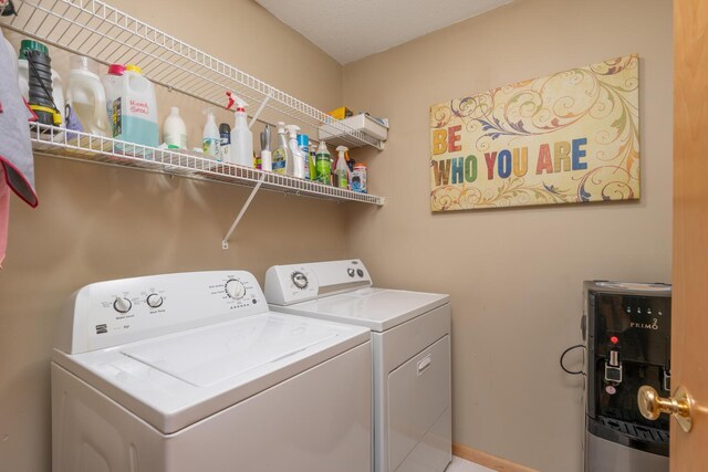 washroom featuring separate washer and dryer and laundry area