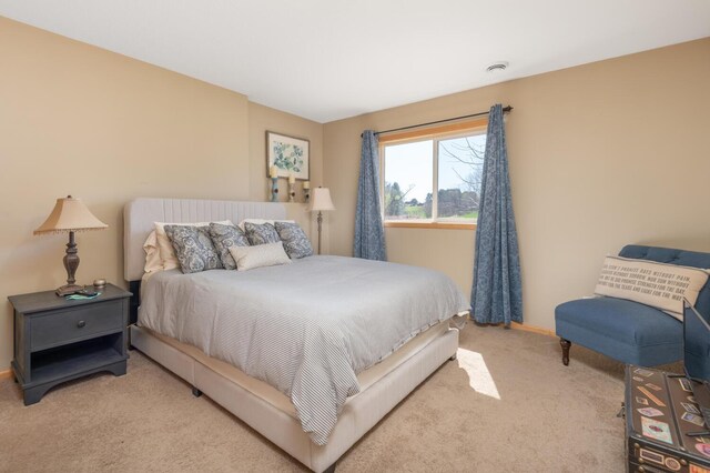 bedroom featuring carpet floors and baseboards