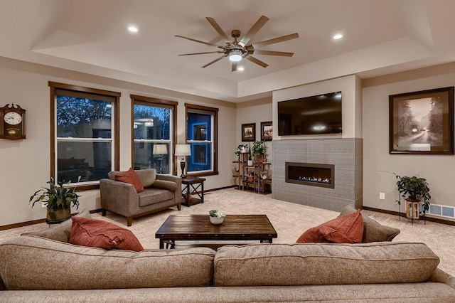 334 143rd Ave NW, Andover, MN 55304 - living room with a raised ceiling, carpet flooring, ceiling fan, baseboards, and a tile fireplace