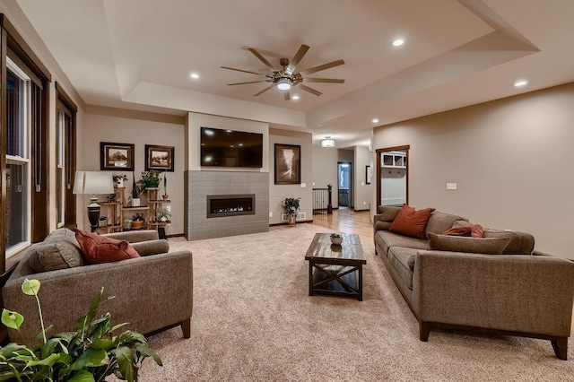 334 143rd Ave NW, Andover, MN 55304 - living room with a raised ceiling, a ceiling fan, light carpet, recessed lighting, and a glass covered fireplace