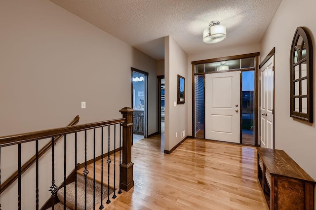 334 143rd Ave NW, Andover, MN 55304 - foyer entrance with light wood-style flooring, a textured ceiling, and baseboards