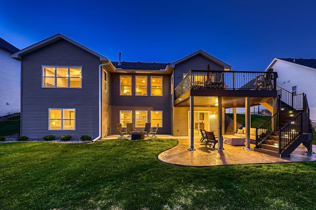 334 143rd Ave NW, Andover, MN 55304 - back of house at night with a patio area, a deck, a yard, stairway, and a fire pit