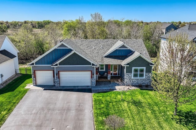 334 143rd Ave NW, Andover, MN 55304 - craftsman inspired home with stone siding, a front lawn, an attached garage, and asphalt driveway