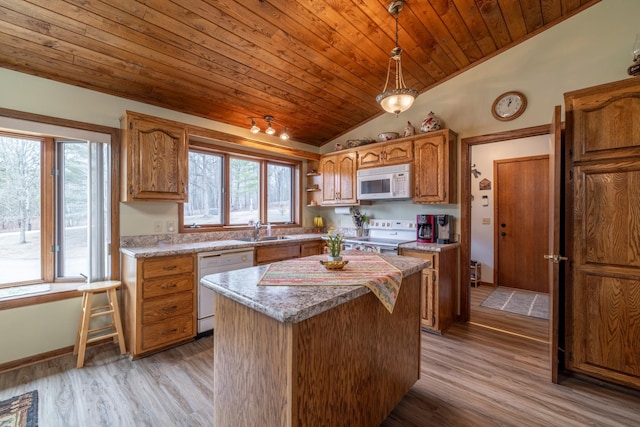 kitchen featuring a sink, wooden ceiling, vaulted ceiling, a wealth of natural light, and white appliances