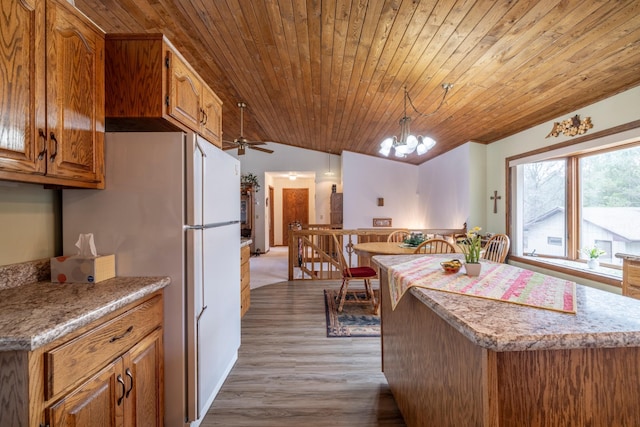 kitchen featuring light wood-style flooring, wood ceiling, freestanding refrigerator, brown cabinetry, and lofted ceiling