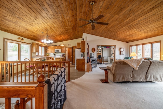 living area with a wealth of natural light, vaulted ceiling, light carpet, and wood ceiling