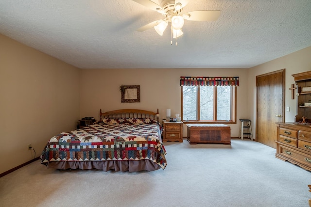 bedroom featuring carpet, ceiling fan, and a textured ceiling