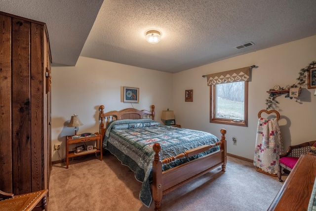 bedroom featuring a textured ceiling, visible vents, baseboards, and light carpet