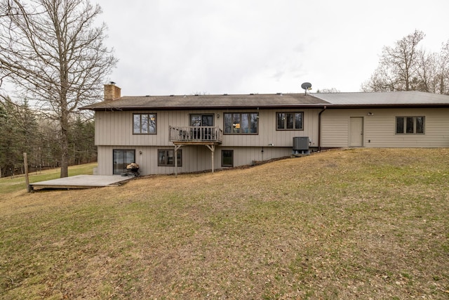 back of property with a yard, central AC, a patio area, and a chimney