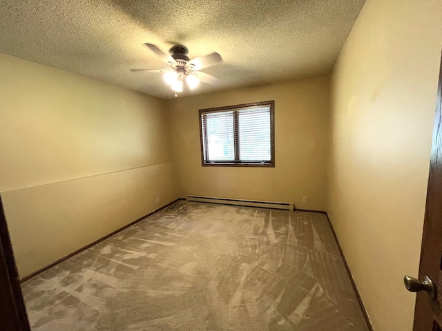 empty room with baseboard heating, a ceiling fan, carpet flooring, a textured ceiling, and baseboards