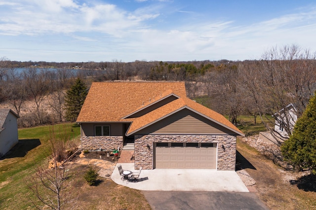 1008 Ruby St NW, Alexandria, MN 56308 - view of front of house with stone siding, asphalt driveway, and a garage