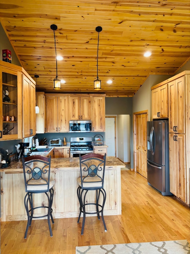 1008 Ruby St NW, Alexandria, MN 56308 - kitchen featuring appliances with stainless steel finishes, a peninsula, a breakfast bar, light wood-style flooring, and wooden ceiling