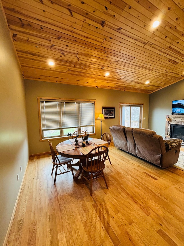 1008 Ruby St NW, Alexandria, MN 56308 - dining space featuring light wood-type flooring, a stone fireplace, baseboards, wooden ceiling, and recessed lighting