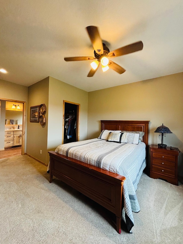 1008 Ruby St NW, Alexandria, MN 56308 - bedroom with light colored carpet, a spacious closet, baseboards, and a ceiling fan