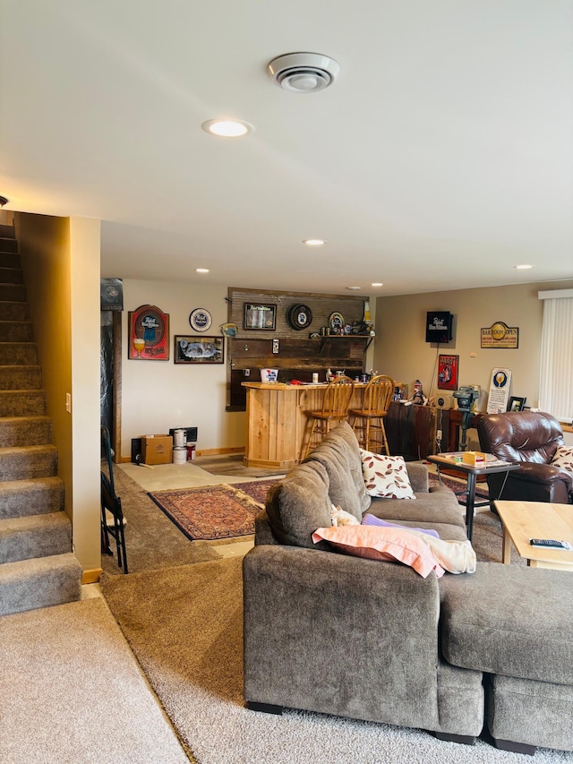 1008 Ruby St NW, Alexandria, MN 56308 - carpeted living area featuring stairway, bar, and recessed lighting