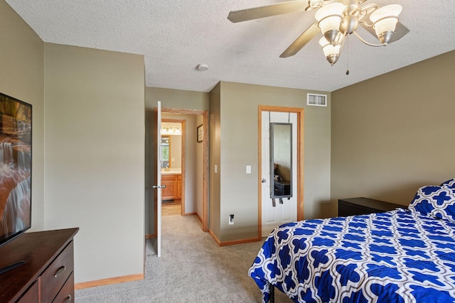bedroom with ceiling fan, light colored carpet, a textured ceiling, baseboards, and visible vents