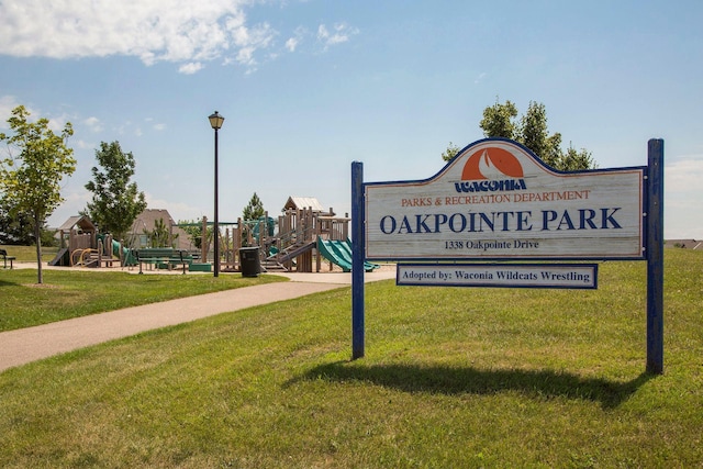 view of home's community featuring a lawn and playground community