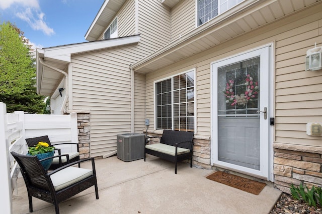 view of patio featuring fence and central AC unit