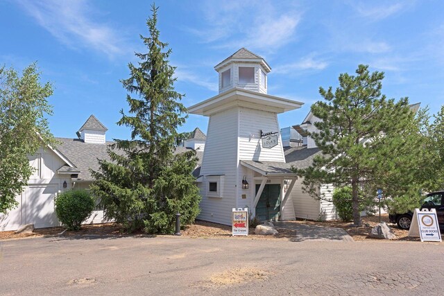 view of front of house featuring a shingled roof