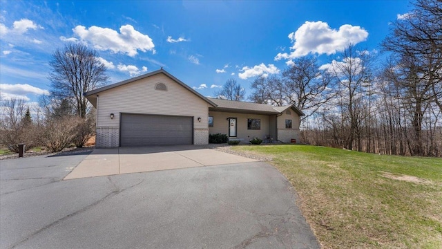ranch-style home with a garage, brick siding, a front lawn, and driveway