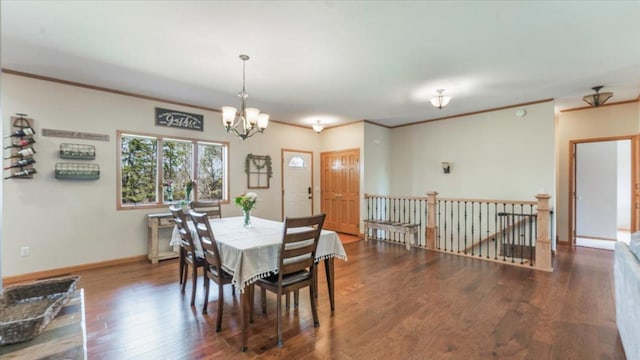 dining space featuring a chandelier, baseboards, wood finished floors, and ornamental molding