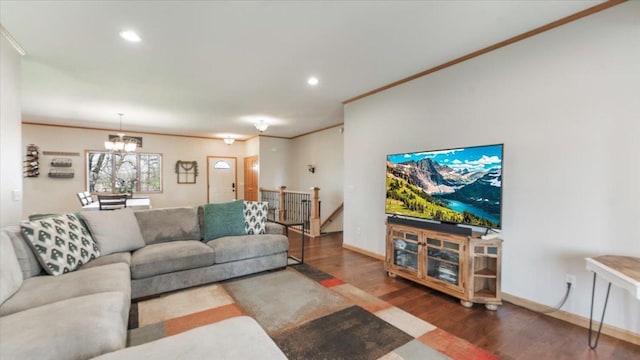 living area featuring crown molding, baseboards, recessed lighting, wood finished floors, and a notable chandelier