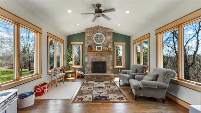 sunroom featuring hardwood / wood-style flooring, a healthy amount of sunlight, and vaulted ceiling