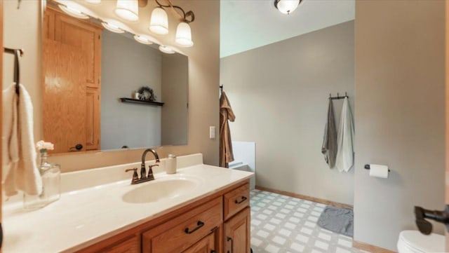 bathroom featuring tile patterned floors, toilet, and vanity