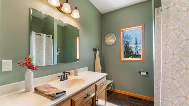 bathroom featuring tile patterned floors, vanity, and baseboards