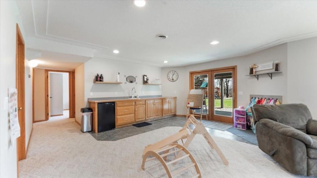 living room featuring french doors, recessed lighting, wet bar, and light carpet