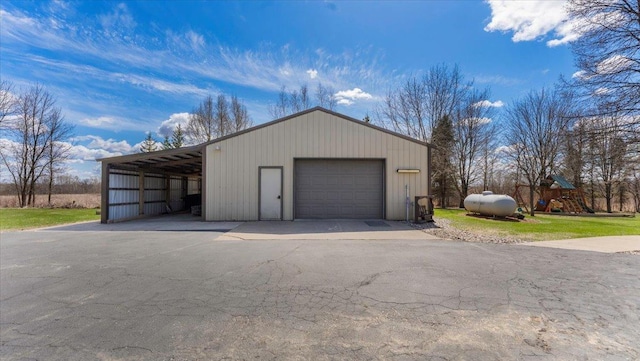 garage with a garage and aphalt driveway