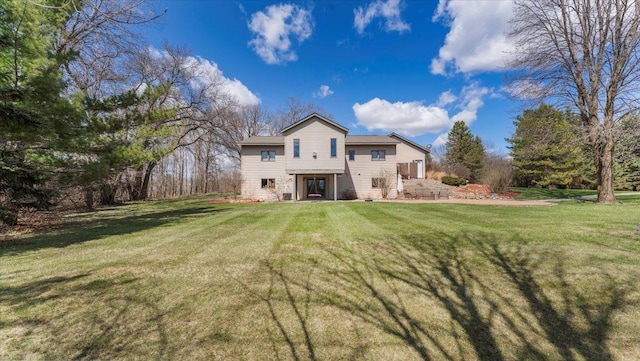 rear view of house with a yard
