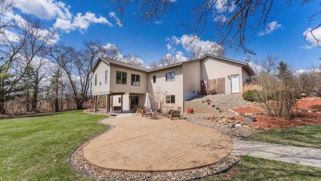 back of property with a patio and a yard