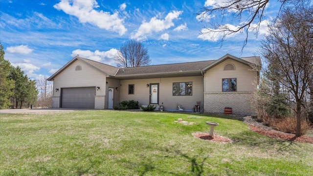 ranch-style house featuring driveway, brick siding, a front yard, and an attached garage